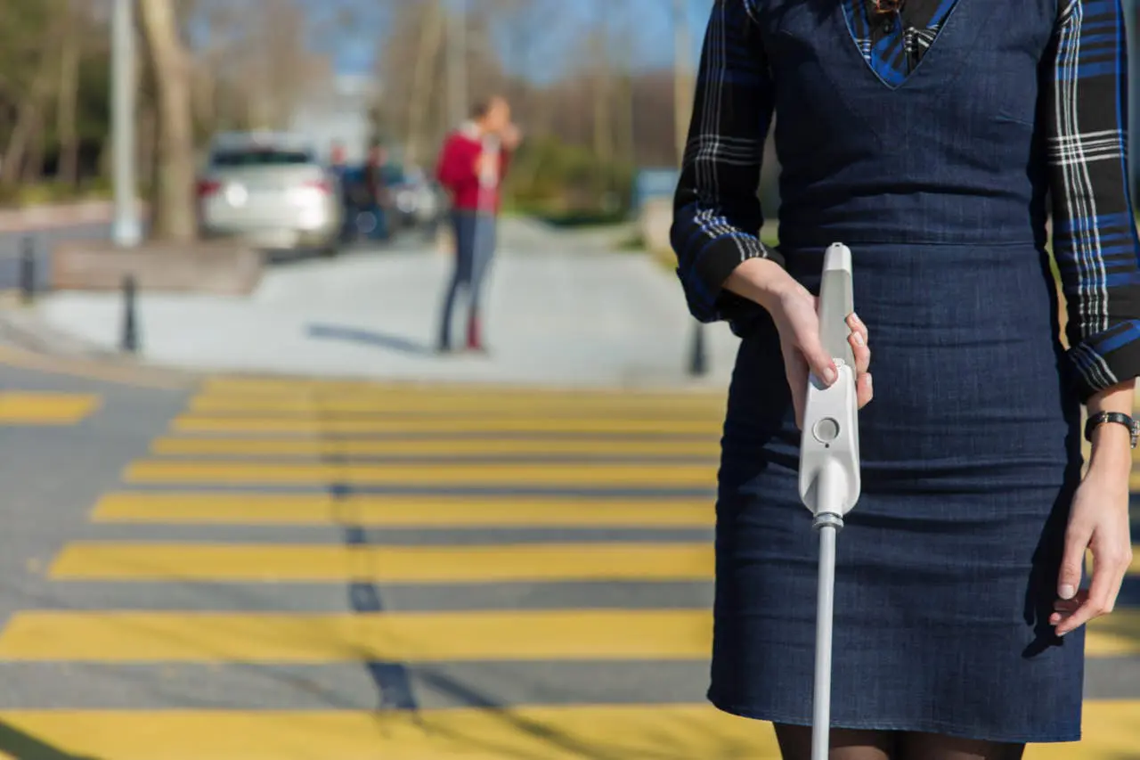 WeWalk smart cane on sidewalk