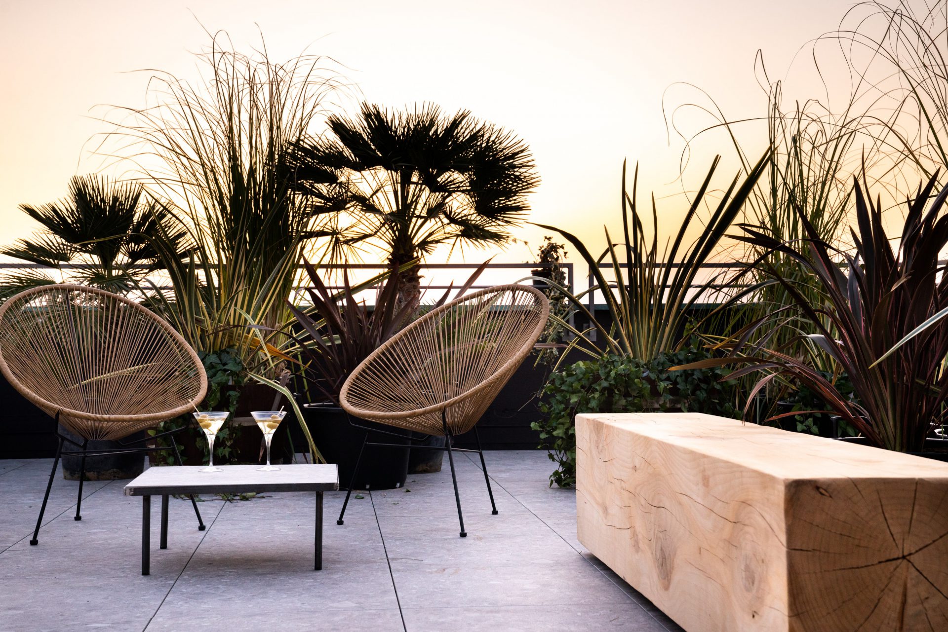 Attico, the terrace is designed with earthy-colored furniture
