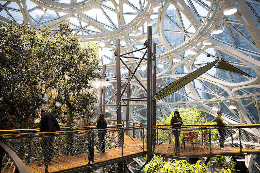 This biophilic architecture is a glass and steel construction consisting of formal spaces and an enormous garden