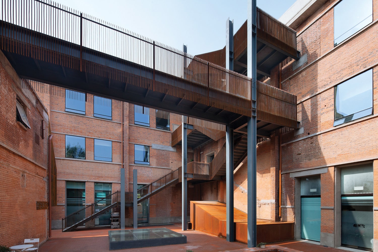 Origin Architects kept weathered steel railings in the courtyard kept as it is 