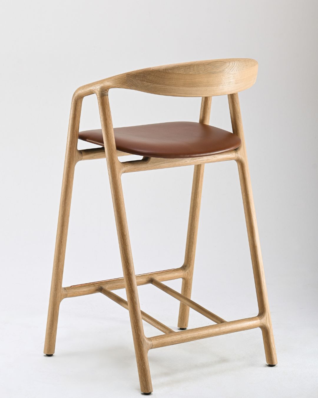 Woak’s Bled Bar Stool can be made of walnut or oak and in five colors. It comes with fabric or leather-upholstered seats. - © Woak